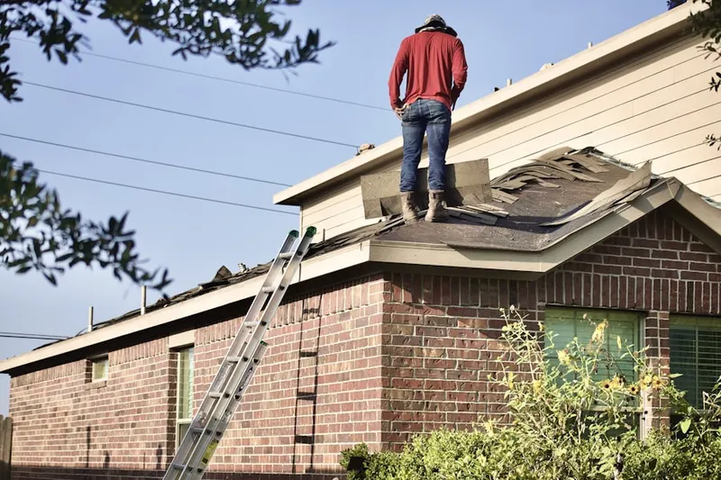 Professional roofer working on a residential roof in Downtown Clayton